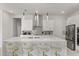 Bright modern kitchen featuring an island with quartz countertops and pendant lighting at 8297 Ivy Stark Blvd, Wesley Chapel, FL 33545