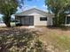 The backyard has trees and a screened in patio at 12800 Kellywood Cir, Hudson, FL 34669