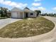 Exterior of home with attached garage and neutral paint at 12800 Kellywood Cir, Hudson, FL 34669