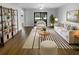 Bright living room with wood floors, white furniture, striped rug, and large sliding glass door at 12800 Kellywood Cir, Hudson, FL 34669