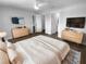 Stylish main bedroom featuring wood floors, modern dressers, and ensuite bathroom at 12800 Kellywood Cir, Hudson, FL 34669