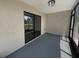 Enclosed sunroom with neutral walls and flooring, with light fixture and glass sliding doors at 12800 Kellywood Cir, Hudson, FL 34669