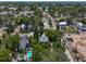 Aerial view of a neighborhood with tree-lined streets, a pool, and single-Gathering homes at 226 N Grosse Ave, Tarpon Springs, FL 34689