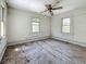 Bedroom with two windows and hardwood floors needs renovation at 226 N Grosse Ave, Tarpon Springs, FL 34689