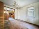 Living room with chandelier and hardwood floors needs renovation at 226 N Grosse Ave, Tarpon Springs, FL 34689