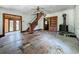 Interior view showcasing the living room with hardwood floors, wood trim, and staircase, revealing renovation potential at 226 N Grosse Ave, Tarpon Springs, FL 34689