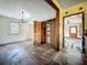 Living room with chandelier and hardwood floors needs renovation at 226 N Grosse Ave, Tarpon Springs, FL 34689