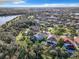 An aerial view of homes backing up to the lake surrounded by lush greenery and mature trees at 5009 Clover Mist Dr, Apollo Beach, FL 33572