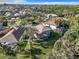 An aerial view of the neighborhood and home surrounded by mature trees at 5009 Clover Mist Dr, Apollo Beach, FL 33572