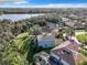 A high aerial view of the home showing nearby lakes, trees, and a lush green lawn at 5009 Clover Mist Dr, Apollo Beach, FL 33572