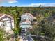 Aerial view of a lovely house with a light blue exterior, a brown roof, and a driveway with a white truck at 5009 Clover Mist Dr, Apollo Beach, FL 33572