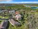 An aerial view of a neighborhood with homes, trees and blue lakes in the background at 5009 Clover Mist Dr, Apollo Beach, FL 33572