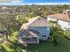 Aerial view of the home, showing the covered back porch, the lush backyard and the roof at 5009 Clover Mist Dr, Apollo Beach, FL 33572