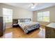 Bedroom featuring hardwood floors, large windows, a ceiling fan, and neutral walls for a bright and airy feel at 5009 Clover Mist Dr, Apollo Beach, FL 33572