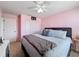 This pink bedroom features a ceiling fan, plush carpet and coordinated furniture at 5009 Clover Mist Dr, Apollo Beach, FL 33572