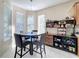 Bright dining area featuring a modern light fixture, round table, and shelving unit with decorative items at 5009 Clover Mist Dr, Apollo Beach, FL 33572