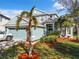 Charming two-story home with a well-manicured lawn, mature trees and a light blue exterior color scheme at 5009 Clover Mist Dr, Apollo Beach, FL 33572