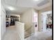 Carpeted second story hallway leading to bedrooms and bonus room, with neutral wall paint and natural lighting at 5009 Clover Mist Dr, Apollo Beach, FL 33572