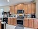 Modern kitchen with stainless steel appliances, light wood cabinets, and plenty of counter space at 5009 Clover Mist Dr, Apollo Beach, FL 33572