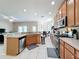 Bright kitchen featuring stainless steel appliances, tile floors, and a view into the living room at 5009 Clover Mist Dr, Apollo Beach, FL 33572