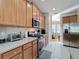 Updated kitchen featuring stainless steel appliances, tile floors, and wood cabinetry at 5009 Clover Mist Dr, Apollo Beach, FL 33572