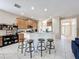 Open concept kitchen with barstool seating, stainless appliances, and views of the home's entry at 5009 Clover Mist Dr, Apollo Beach, FL 33572
