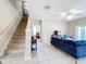 Open-concept living room with staircase and view of the adjacent room at 5009 Clover Mist Dr, Apollo Beach, FL 33572
