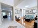 Bright living room with hardwood floors, stylish decor, and lots of natural light at 5009 Clover Mist Dr, Apollo Beach, FL 33572