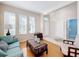 Bright living room with large windows, hardwood floors, and elegant furniture arrangement at 5009 Clover Mist Dr, Apollo Beach, FL 33572