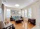 Light-filled living room boasts hardwood floors, multiple windows, and modern furnishings at 5009 Clover Mist Dr, Apollo Beach, FL 33572