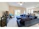 Cozy living room featuring a comfortable blue sectional, sliding glass doors to the back and tile floors at 5009 Clover Mist Dr, Apollo Beach, FL 33572