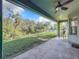 Covered patio with concrete flooring looking out to a lush yard with mature trees at 5009 Clover Mist Dr, Apollo Beach, FL 33572