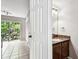View into a bathroom with granite countertop, wood vanity and neutral walls at 609 S Glen Ave # E, Tampa, FL 33609