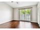Bright bedroom featuring hardwood floors and a large window with natural light at 609 S Glen Ave # E, Tampa, FL 33609