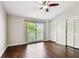Bedroom featuring hardwood floors, ceiling fan, and closet at 609 S Glen Ave # E, Tampa, FL 33609