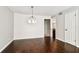 Light-filled dining room features hardwood floors and stylish light fixture at 609 S Glen Ave # E, Tampa, FL 33609