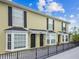 Street view of tan-colored building with black doors and window shutters, showcasing its facade at 609 S Glen Ave # E, Tampa, FL 33609