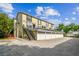 Exterior shot of a three-story townhome with individual garages and outdoor stairwell at 609 S Glen Ave # E, Tampa, FL 33609