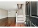 View of the foyer with beautiful hardwood floors and stairs leading to the upper level at 609 S Glen Ave # E, Tampa, FL 33609