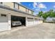 Spacious four car garage with automatic doors and a white car parked inside at 609 S Glen Ave # E, Tampa, FL 33609