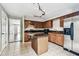View of the kitchen with stainless appliances, stone counters and center island at 609 S Glen Ave # E, Tampa, FL 33609