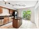 Kitchen with a center island, stainless steel appliances, and sliding doors to a balcony at 609 S Glen Ave # E, Tampa, FL 33609