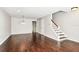 Spacious living room featuring hardwood floors with stairs leading to the upper level at 609 S Glen Ave # E, Tampa, FL 33609