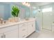 Modern bathroom with dual sinks, quartz counters, a glass-enclosed shower, and bright lighting at 1079 Signet, Apollo Beach, FL 33572