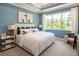 Spacious bedroom with a large window, comfortable seating, and stylish decor at 1079 Signet, Apollo Beach, FL 33572