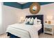 Comfortable bedroom with modern design and furnishings, natural light and a round mirror at 1079 Signet, Apollo Beach, FL 33572