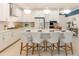 Bright, modern kitchen with white cabinetry, stainless steel appliances, and a large center island with seating at 1079 Signet, Apollo Beach, FL 33572