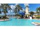 Community pool with a light house themed water slide tower and ample sun bathing space at 1079 Signet, Apollo Beach, FL 33572