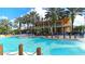 Community pool with lounge chairs and palm trees, backed by an impressive multi-story building at 1079 Signet, Apollo Beach, FL 33572