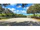 A sandy volleyball court with trees and landscaping in a community park on a sunny day at 1079 Signet, Apollo Beach, FL 33572
